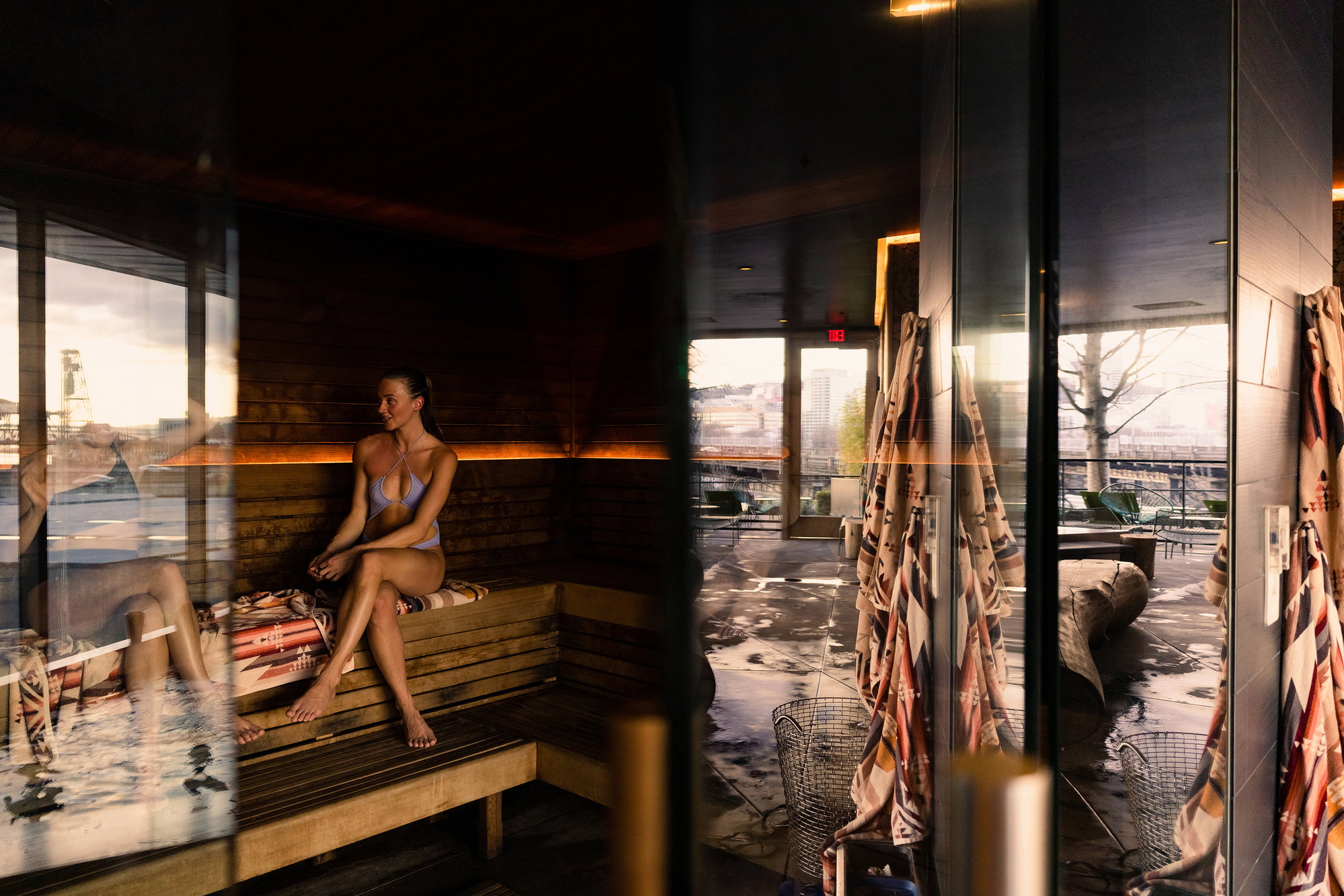 Portlanders in swimsuits chat in Knot Springs' sauna.