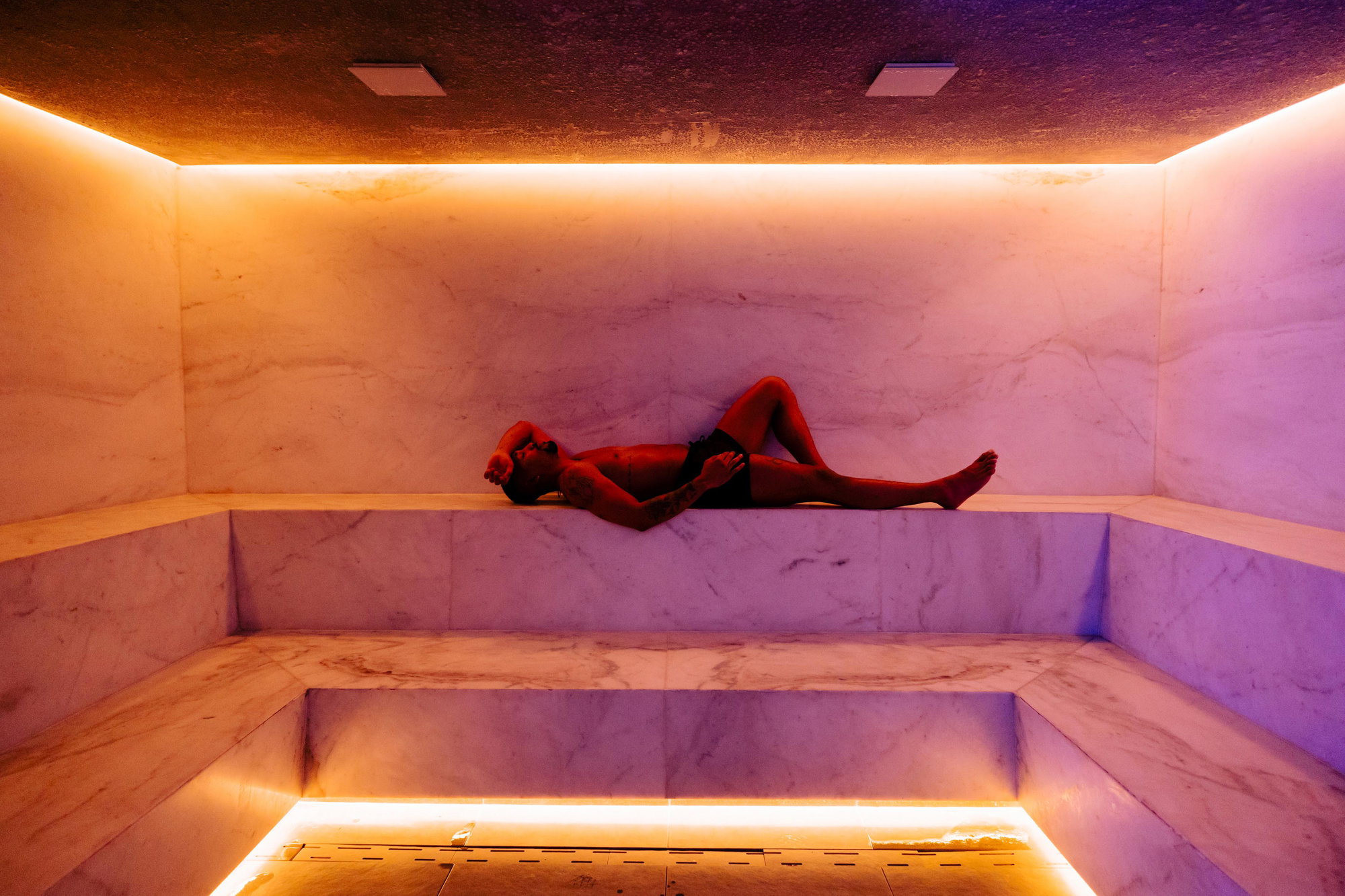 A person lies in a marble sauna at Cascada.